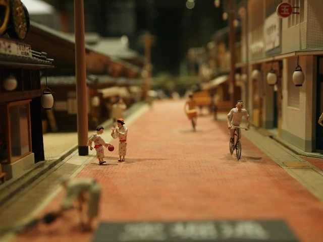 Miniature Chinatown street with traditional architecture, warm lighting, and pedestrian walkways