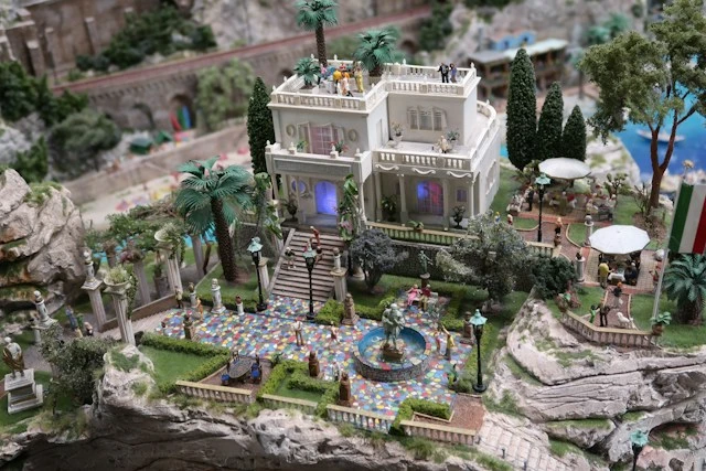 Miniature villa surrounded by landscaped gardens and greenery
